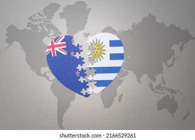 puzzle heart with the national flag of new zealand and uruguay on a world map background. Concept. 3D illustration