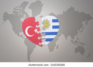 puzzle heart with the national flag of turkey and uruguay on a world map background. Concept. 3D illustration