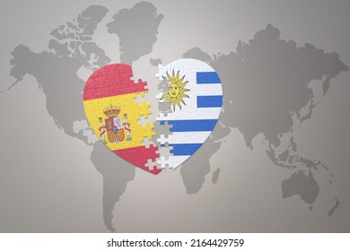 puzzle heart with the national flag of uruguay and spain on a world map background. Concept. 3D illustration