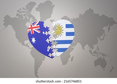 puzzle heart with the national flag of uruguay and australia on a world map background. Concept. 3D illustration