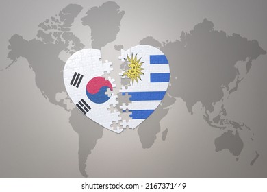 puzzle heart with the national flag of uruguay and south korea on a world map background. Concept. 3D illustration