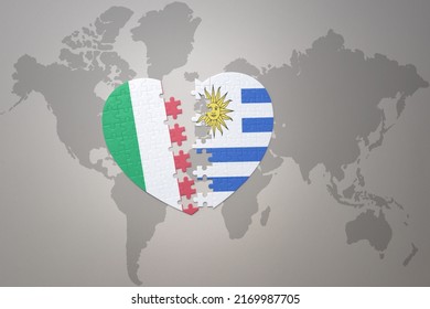 puzzle heart with the national flag of uruguay and italy on a world map background.Concept. 3D illustration