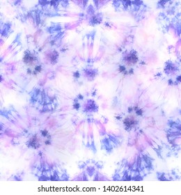 Quality tie dye repeat pattern in muted hues of pink and purple. Seamless pattern. 
