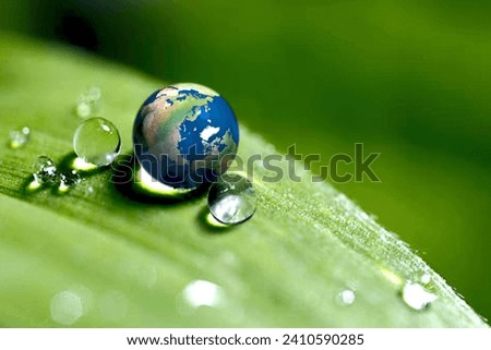 rain drop on a leaf reflecting earth concept for environmental conservation "Elements of earth image courtesy NASA"