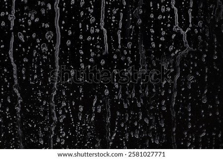 Raindrops spread out on a black background