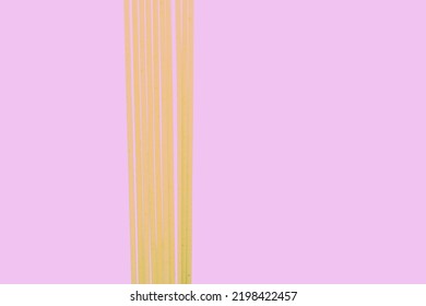 Raw Spaghetti On Purple Background, Yellow Food On Purple Background, Vertical Lines On Purple Background