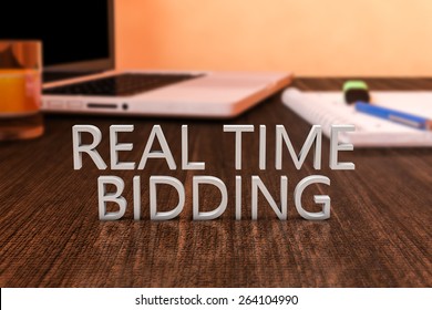 Real Time Bidding - Letters On Wooden Desk With Laptop Computer And A Notebook. 3d Render Illustration.