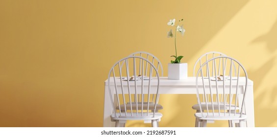 Realistic 3D Render Modern Bright Yellow Dining Space With White Wooden Table And Chairs For Family By The Window With Sunlight And Empty Wall For Household Products Display Templates, Backdrop, Home.