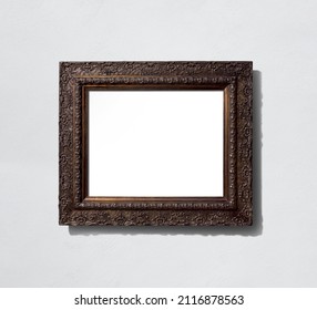 Realistic baroque decorated dark wooden frame illustration isolated on wall background with blank inner area suitable for artwork or photographic mock-ups.