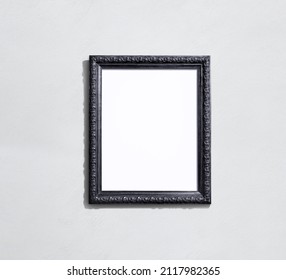 Realistic baroque decorated dark wooden slim frame illustration isolated on wall background with blank inner area suitable for artwork or photographic mock-ups.