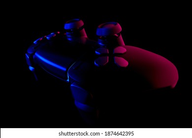 Realistic video game controller in neon lights on black noir background. 3D rendering of streaming gear and virtual reality concept