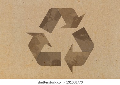 Recycle icon on cardboard  background closeup - Shutterstock ID 131058773