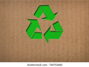 recycle symbol on cardboard texture - Shutterstock ID 744753460