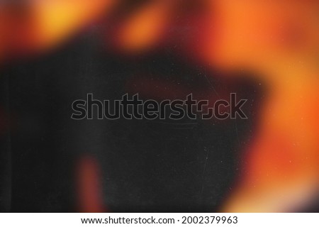 Red blurred effect on balck background. Illustration. Retro wallpaper. Old analog film photo texture