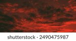red and dark clouds beautiful sunset ambiance with large yellow and orange sun in he sky surface hills