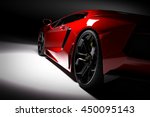 Red fast sports car in spotlight, black background. Shiny, new, luxurious. 3D rendering