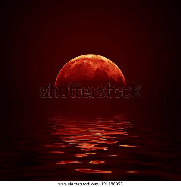 Red moon reflected
in a wavy water
surface
