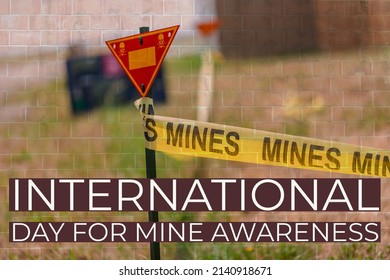 Red triangle alert mines yellow tape showing landmines and text written international day for mine awareness having bricks in background