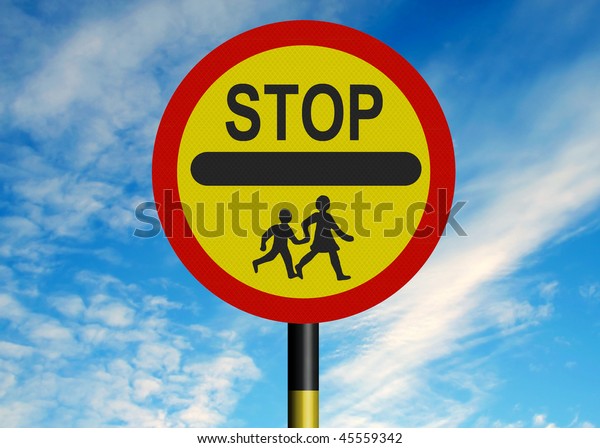 Reflective metallic school crossing patrol\
\'lollipop\' sign, against a blue\
sky.