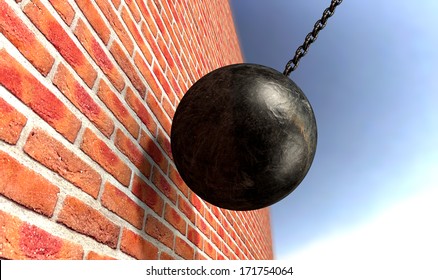 A regular metal wrecking ball attached to a chain hitting and breaking a face brick