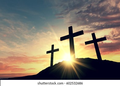 Religious cross silhouette against a bight sunrise sky