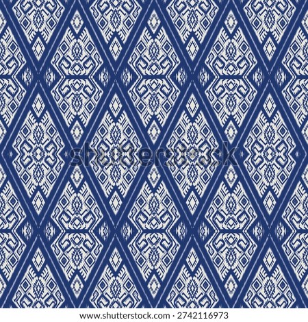 Repeating geometric pattern inspired by traditional Ikat weaving techniques. Featuring a classic indigo blue and white color palette, the design showcase intricate diamond shaped motifs with feathered edges characteristic of tie dye textile arts. Ideal for ethnic themed backgrounds, fashion textile, interior wallpaper and cultural graphic design projects.