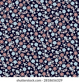 A repeating pattern of tiny, colorful flowers scattered across a dark navy blue background, creating a charming and intricate design.