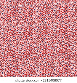 A repeating pattern of tiny red flowers with dark blue centers scattered across a white surface, creating a vibrant and cheerful textile design.