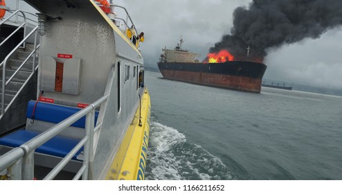 A Rescue Boat Heads Towards A Fuel Ship On Fire.