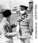 Respirator for British soldiers- a nurse demonstrates a facemask on a British soldier during the influenza epidemic, ca.1918