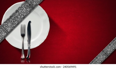 Restaurant Menu Design. Red velvet background with diagonal silver floral bands, empty white plate and silver cutlery. Template for an elegant restaurant menu - Powered by Shutterstock