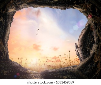  
Resurrection of Easter Sunday concept: Tomb stone with meadow autumn sunset background