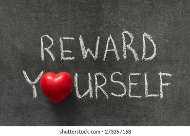 Reward Yourself Phrase Handwritten On Blackboard With Heart Symbol Instead Of O 