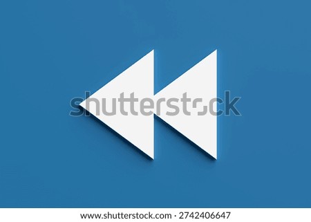 Rewind button icon on a blue background, representing multimedia player functions, past, backwards, or previous actions