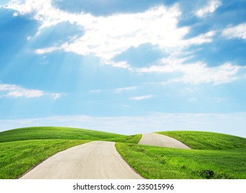 Road Running Through Green Hills Towards Horison