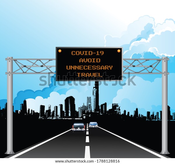 Roadway overhead digital gantry sign with COVID 19\
Coronavirus avoid unnecessary travel message set against a blue\
cloudy sky 