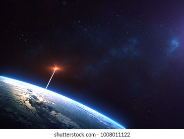 Rocket Launch From The Earth Planet Orbit  Through The Clouds With A Bright Glow Of The Engine On The Foreground And A Bright Blue Nebula Galaxy. Elements Of This Image Furnished By NASA