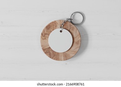 Round Plastic Keychain On A Wooden Stand Mockup. 3D Rendering