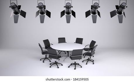 Round Table And Eight Office Chairs On A Gray Background. On The Ceiling Of The Studio Lighting Lamps. Cooperation Concept