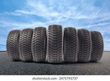 A row of car tires on the asphalt and a blue sky, 3d Rendering - Powered by Shutterstock