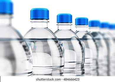 Row of plastic bottles with clear purified drink carbonated water isolated on white background with selective focus effect