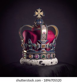 Royal Golden Crown With Jewels On Pillow On Black Background. Symbols Of UK United Kingdom Monarchy. 3d Illustration