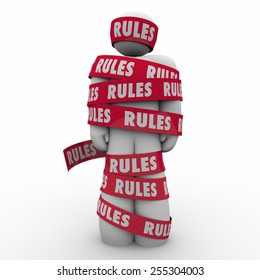 Rules Word On Red Tape Wrapped Around A Man Or Person To Illustrate Following Regulations, Guidance Or Laws To Be In Compliance 