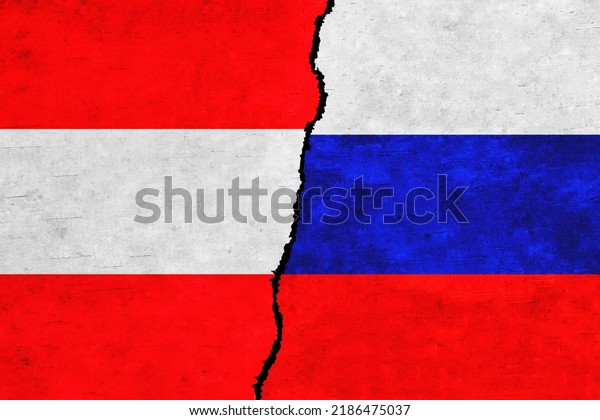 Russia and Austria painted flags on a wall with\
a crack. Russia and Austria relations. Austria and Russia flags\
together