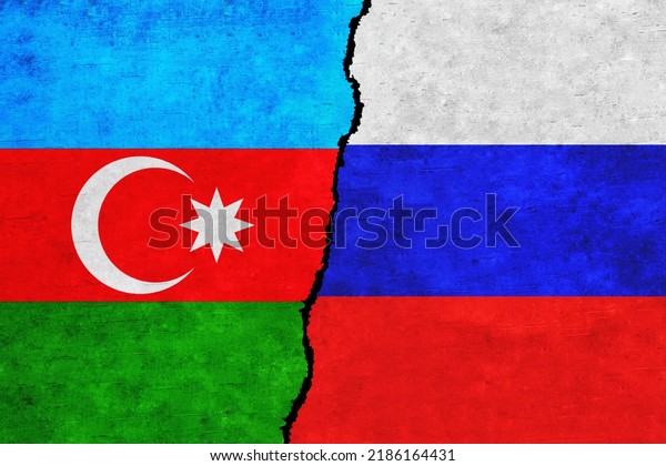 Russia and Azerbaijan painted flags on a wall\
with a crack. Russia and Azerbaijan relations. Azerbaijan and\
Russia flags\
together