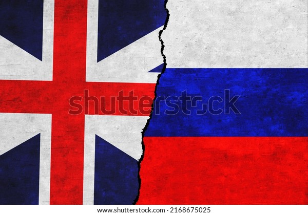 Russia and Britain painted flags on a wall with\
a crack. Russia and Great Britain relations. Great Britain and\
Russia flags\
together