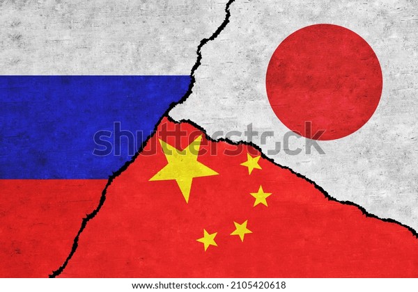 Russia, China and Japan painted\
flags on a wall with a crack. China, Japan and Russia\
relations