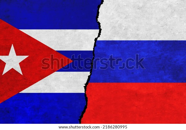 Russia and Cuba\
painted flags on a wall with a crack. Russia and Cuba relations.\
Cuba and Russia flags\
together