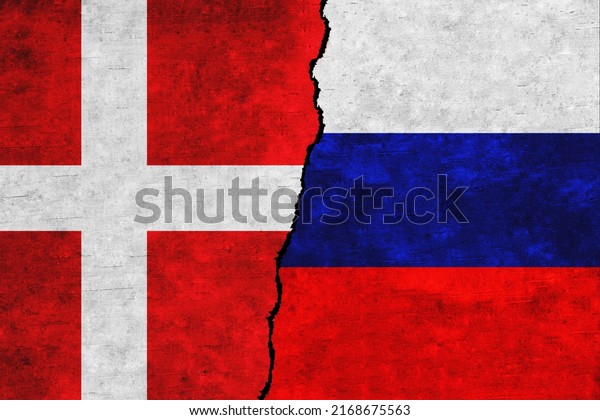 Russia and Denmark painted flags on a wall with\
a crack. Russia and Denmark relations. Denmark and Russia flags\
together