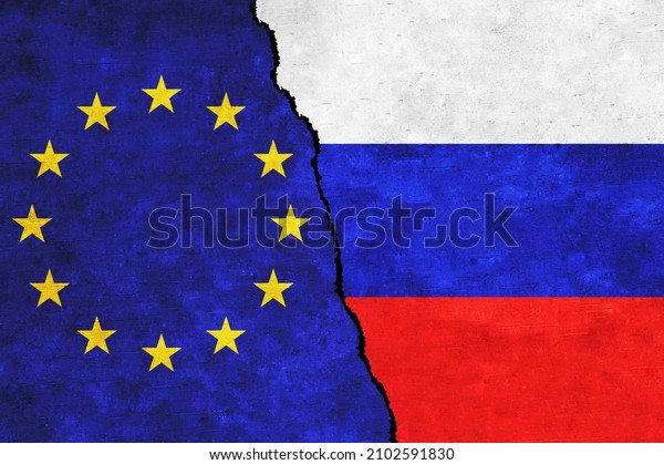 Russia and\
EU painted flags on a wall with a crack. Russia and European Union\
conflicts. EU and Russia flags\
together